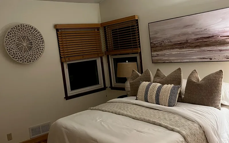 Cozy bedroom with warm neutral paint tones and vaulted ceiling