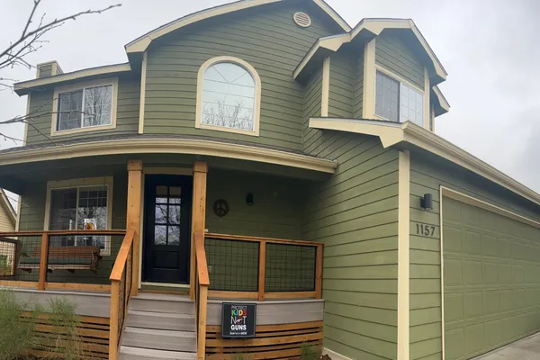 Green exterior house painting with cedar accents in Fort Collins Colorado
